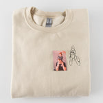 a t - shirt with a picture of a person holding a baby