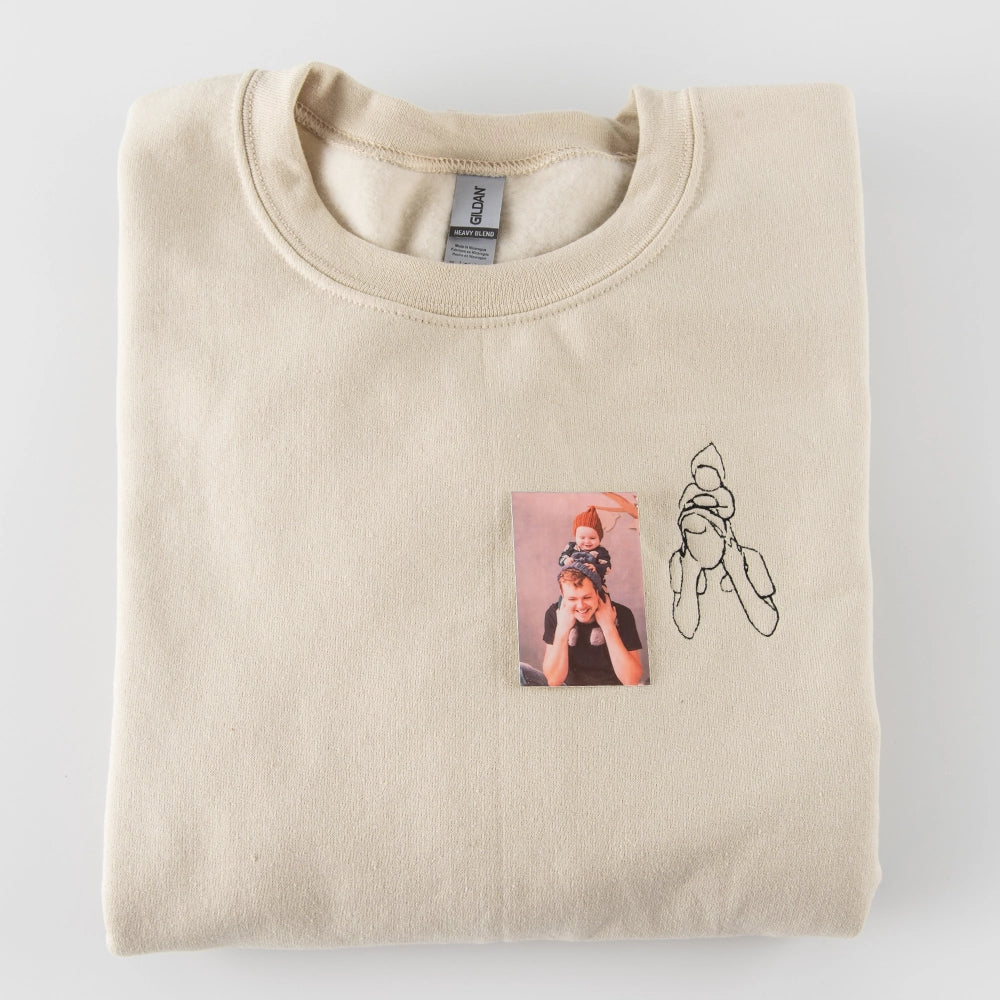 a t - shirt with a picture of a person holding a baby