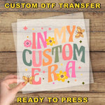 a hand holding a piece of paper with the words in my custom era