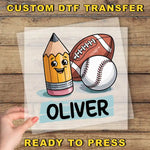 A hand is holding a transparent sheet with a cartoon image of a pencil, a baseball, and a football, along with the name "Olivier" written below.