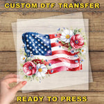 a hand holding a piece of paper with an american flag on it