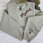 a couple of sweatshirts sitting on top of a bed