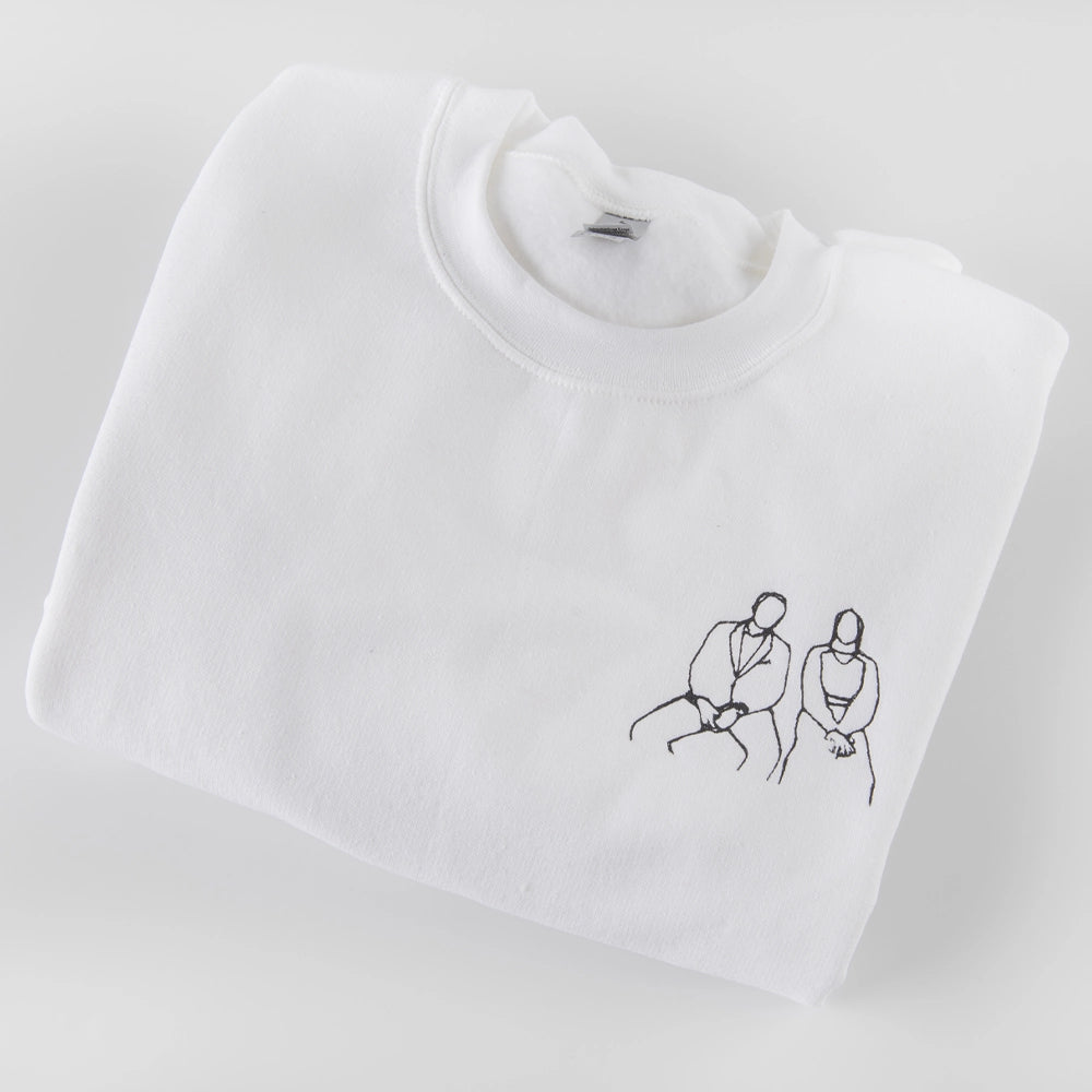 a white t - shirt with a drawing of two people on it