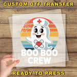 a person holding up a sticker that says boo boo crew