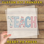 a hand holding a piece of paper with the word "TEACH" written on it, along with a text overlay that says "CUSTOM DTF TRANSFER" and "READY TO PRESS".