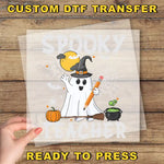 a hand holding a paper with a ghost on it