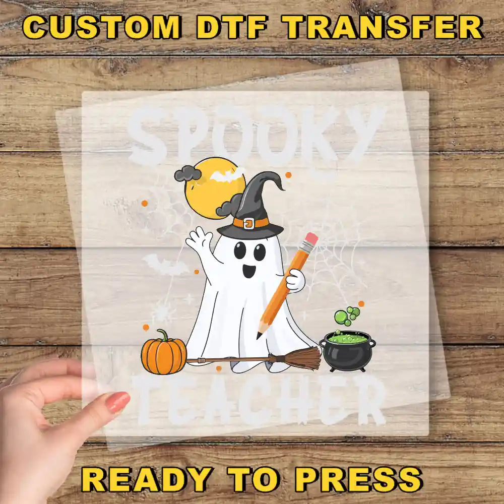 a hand holding a paper with a ghost on it