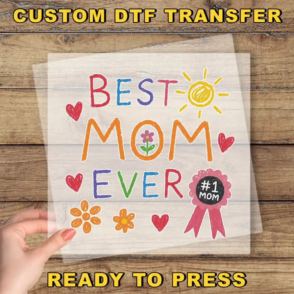 a person holding a piece of paper with the words best mom ever on it