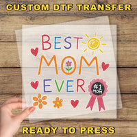 a person holding a piece of paper with the words best mom ever on it