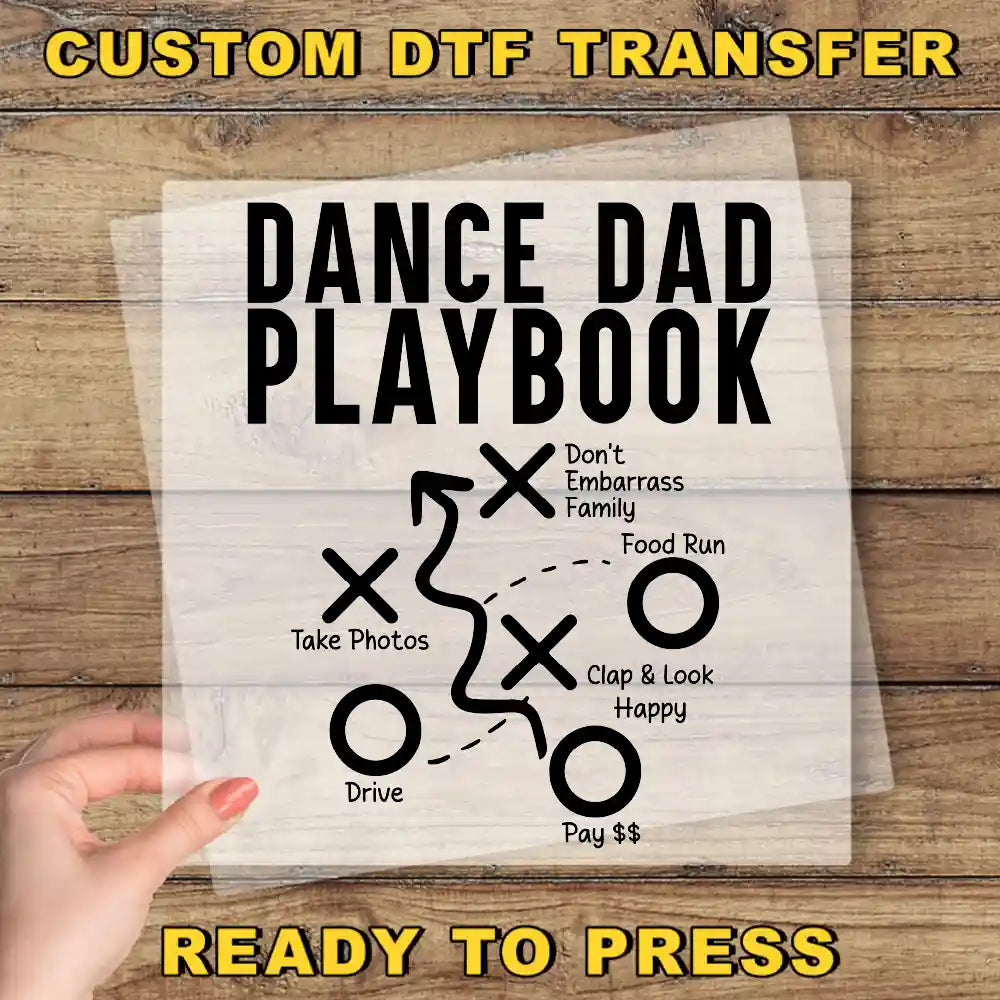 a hand holding a piece of paper that says dance dad playbook ready to press