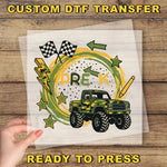 a hand holding a piece of paper with a custom DTF transfer design on it. The design includes a truck, checkered flags, lightning bolts, stars, and the word "PREK" written on it.