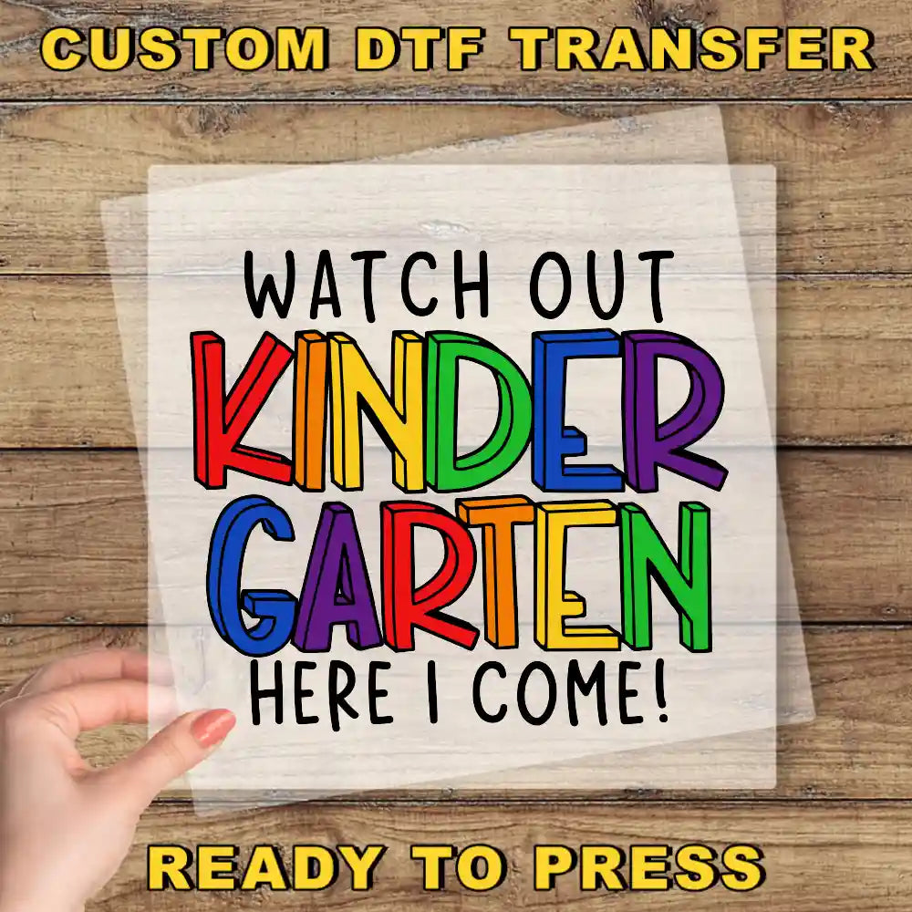 a hand holding a piece of paper that says, watch out kinder garden here