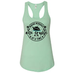 A mint green tank top with a graphic design featuring a cruise ship and the text "Making memories one cruise at a time".