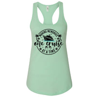 A mint green tank top with a graphic design featuring a cruise ship and the text "Making memories one cruise at a time".