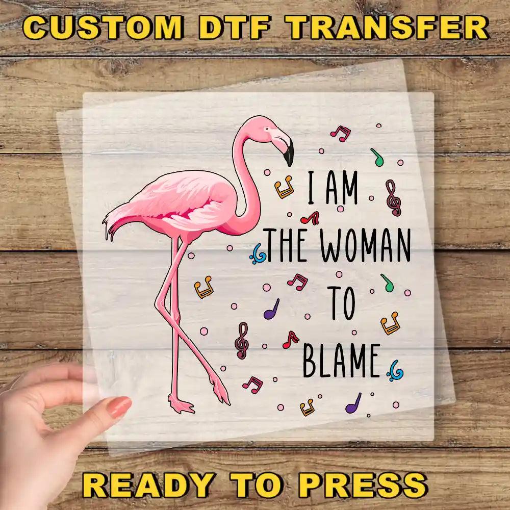 a pink flamingo with the words, i am the woman to blame