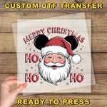 a hand holding a piece of paper with a santa clause on it