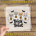 a hand holding a paper with a trick or treat design on it