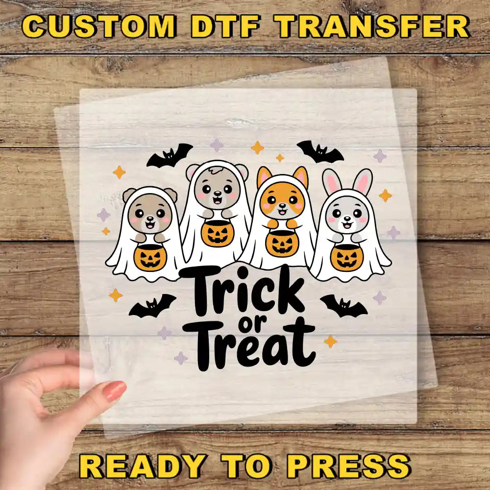a hand holding a paper with a trick or treat design on it