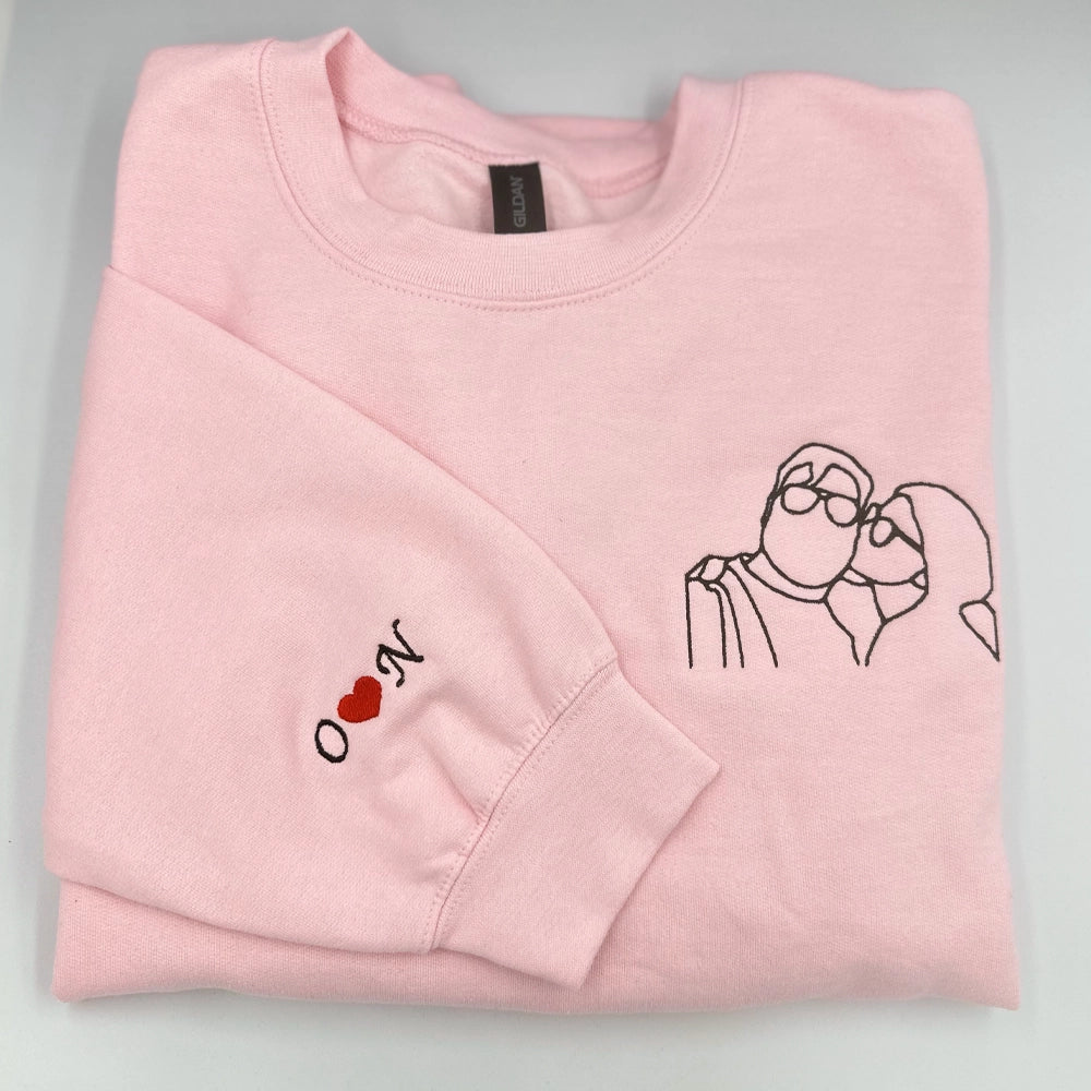 a pink sweatshirt with a picture of a dog and a heart on it