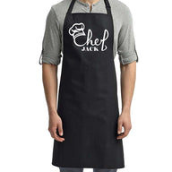 a man wearing a black chef's apron