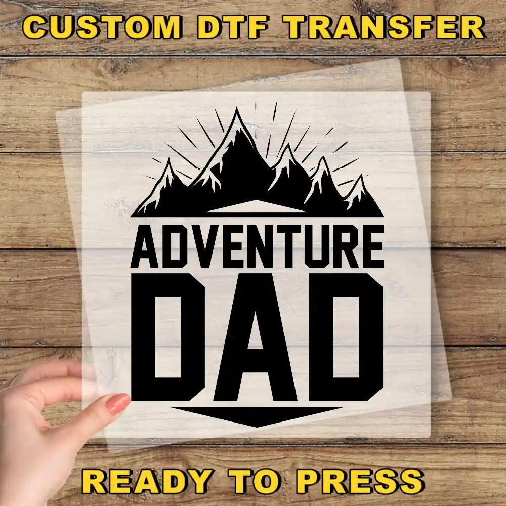 a person holding up a paper with the words adventure dad on it