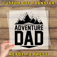 a person holding up a paper with the words adventure dad on it