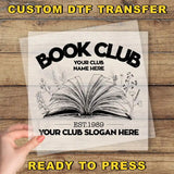 a book club sign with a hand holding a book