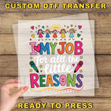 The image is a hand holding a clear sheet with a colorful and playful design featuring children and text.