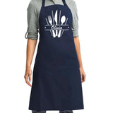 a woman wearing an apron with a knife and fork on it