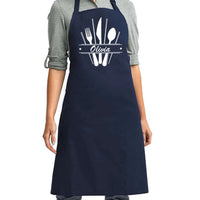 a woman wearing an apron with a knife and fork on it