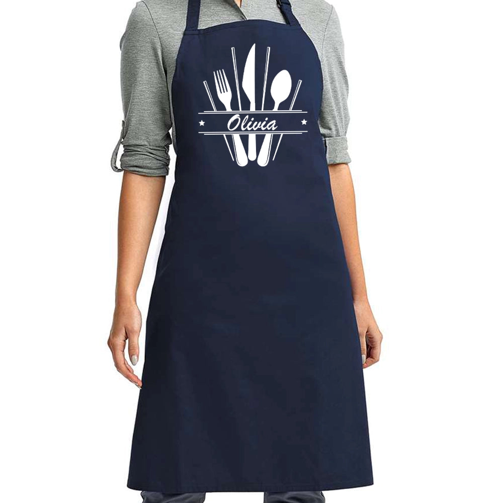 a woman wearing an apron with a knife and fork on it