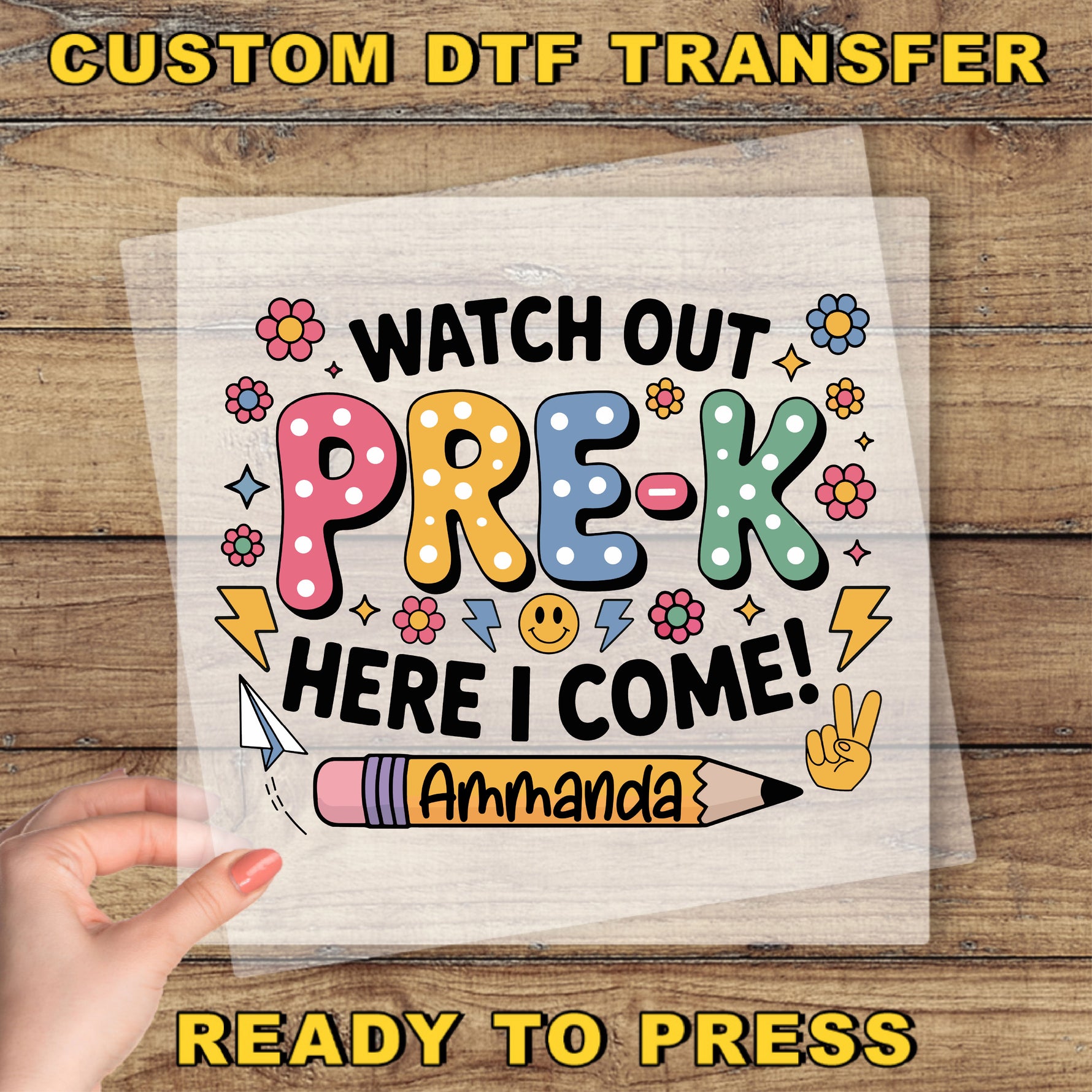 The image is a hand holding a sheet of paper with a colorful and playful design featuring text and illustrations related to pre-k education.