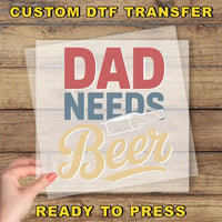 a hand holding a piece of paper that says, dad needs beer ready to press