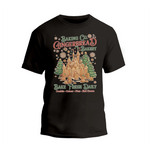 A black t-shirt with a graphic design featuring a gingerbread house and snowflakes, along with text promoting a bakery.