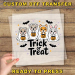 a hand holding a paper with a trick or treat design on it