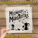 a hand holding a piece of paper with the words midnight margaritas ready to press