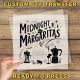 a hand holding a piece of paper with the words midnight margaritas ready to press