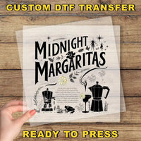 a hand holding a piece of paper with the words midnight margaritas ready to press