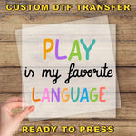 a hand holding a piece of paper that says play in my favorite language