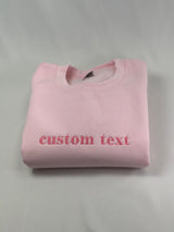 a pink t - shirt that says custom text