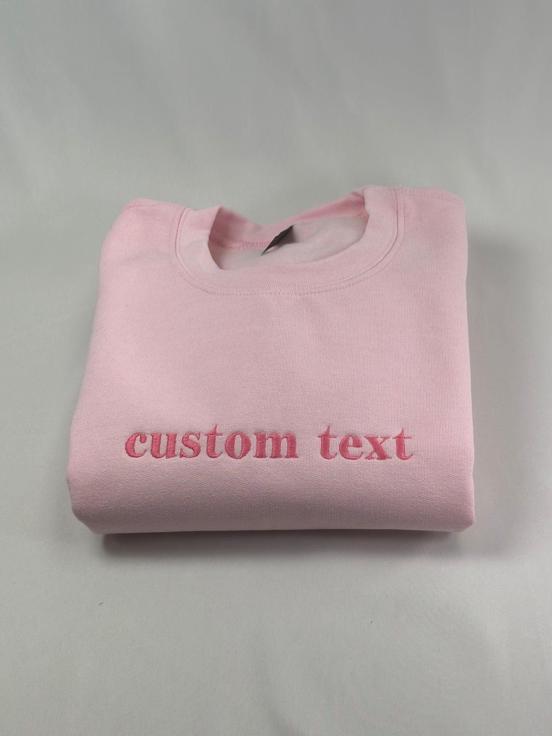 a pink t - shirt that says custom text