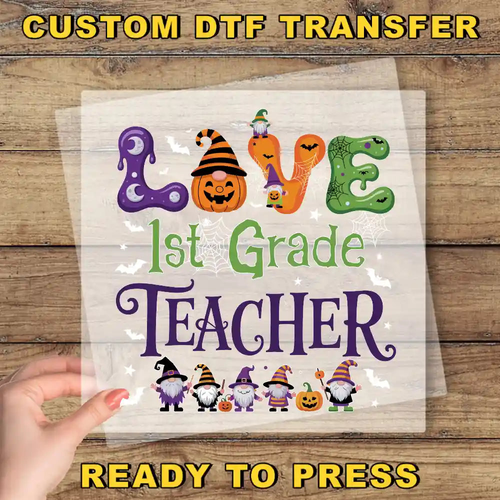 The image is a Halloween-themed poster with the text "LOVE 1st Grade TEACHER" and various Halloween-themed illustrations, including a pumpkin, spider, and gnome characters.