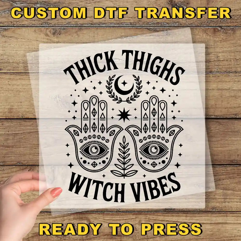 a hand holding a paper with the words trick thighs witch vibes ready to press