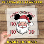 a hand holding a piece of paper with a santa clause on it