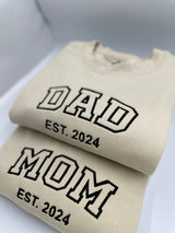 a pair of t - shirts with the words dad and mom printed on them
