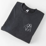 a black t - shirt with a picture of two people hugging