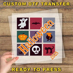 a hand holding a piece of paper with halloween images on it