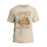 A t-shirt design featuring a gingerbread house and text promoting a bakery.