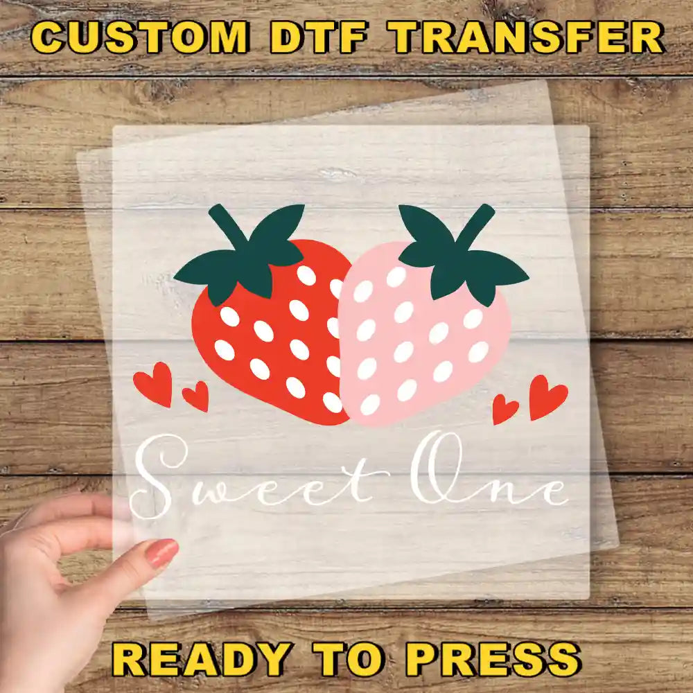 a hand holding a piece of paper with a strawberry on it