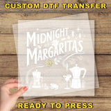 a person holding a piece of paper with the words midnight margaritas ready to press